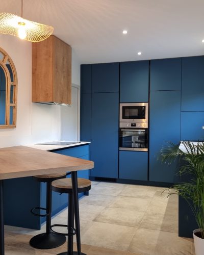 une cuisine ouverte bleue avec un plan de travail en bois
